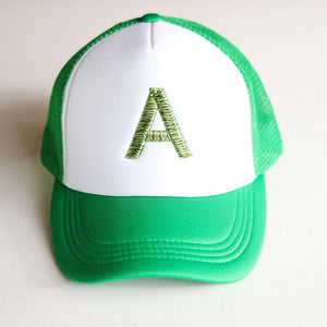 Green and white cap with a green letter 'A' on a white background