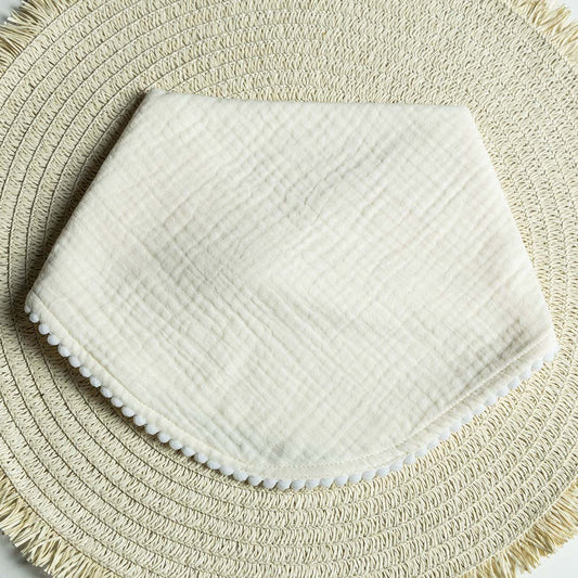 MUSLIN POM POM BIB: FLORAL MONOGRAM