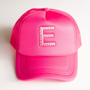 Pink trucket hat with a 3d puff weave variegated letter 'E' on a white background