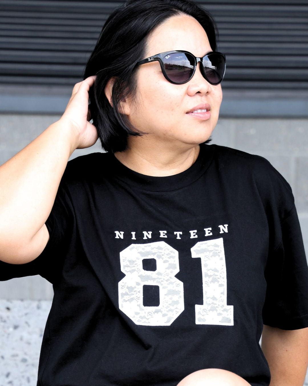 Black Martina Tee embroidered with Nineteen 81 in lace applique