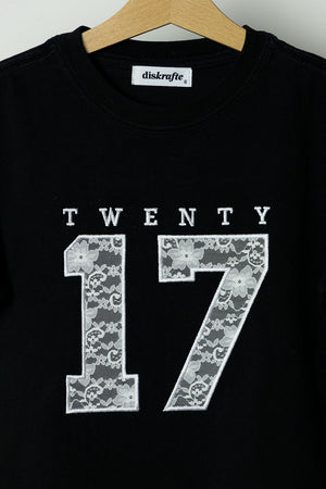 Black t-shirt with 'TWENTY 17' applique embroidered in white lace design 