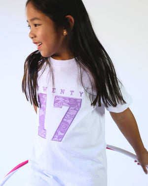 Child wearing a white t-shirt with 'TWENTY 17'  in lilac lace applique embroidery